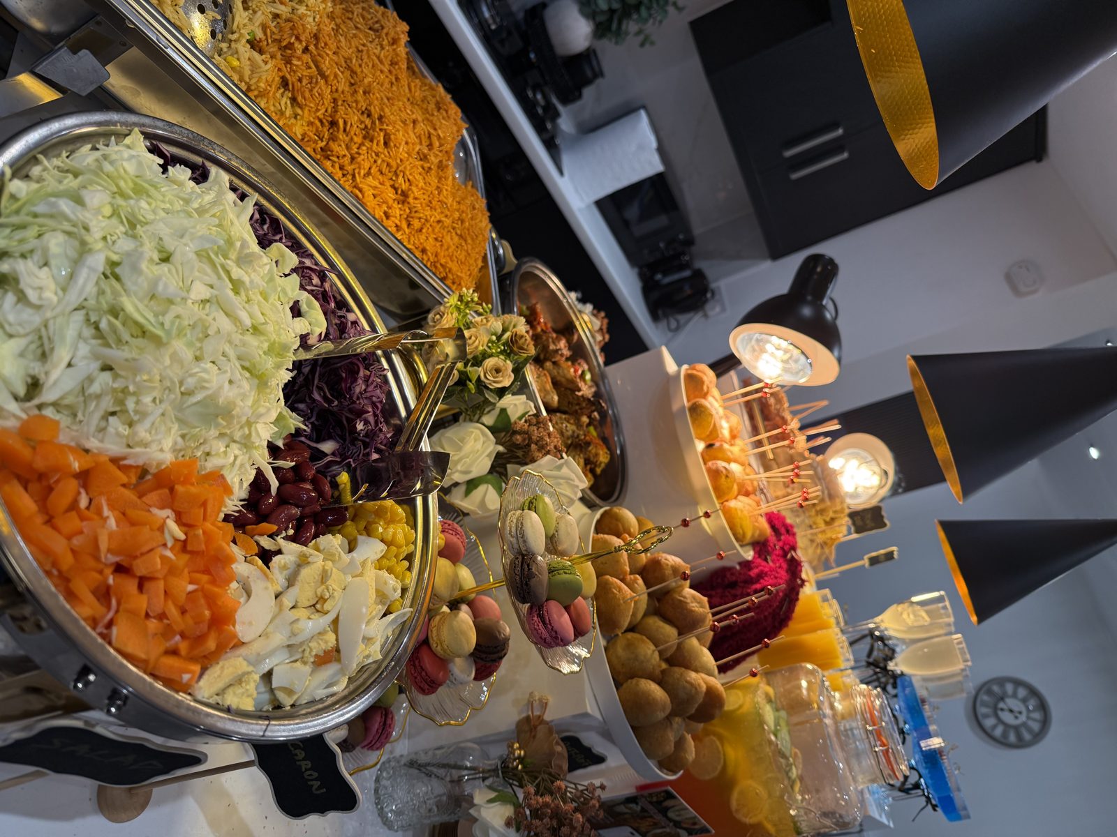 Grazing table with jollof rice, canapes, macarons and drinks