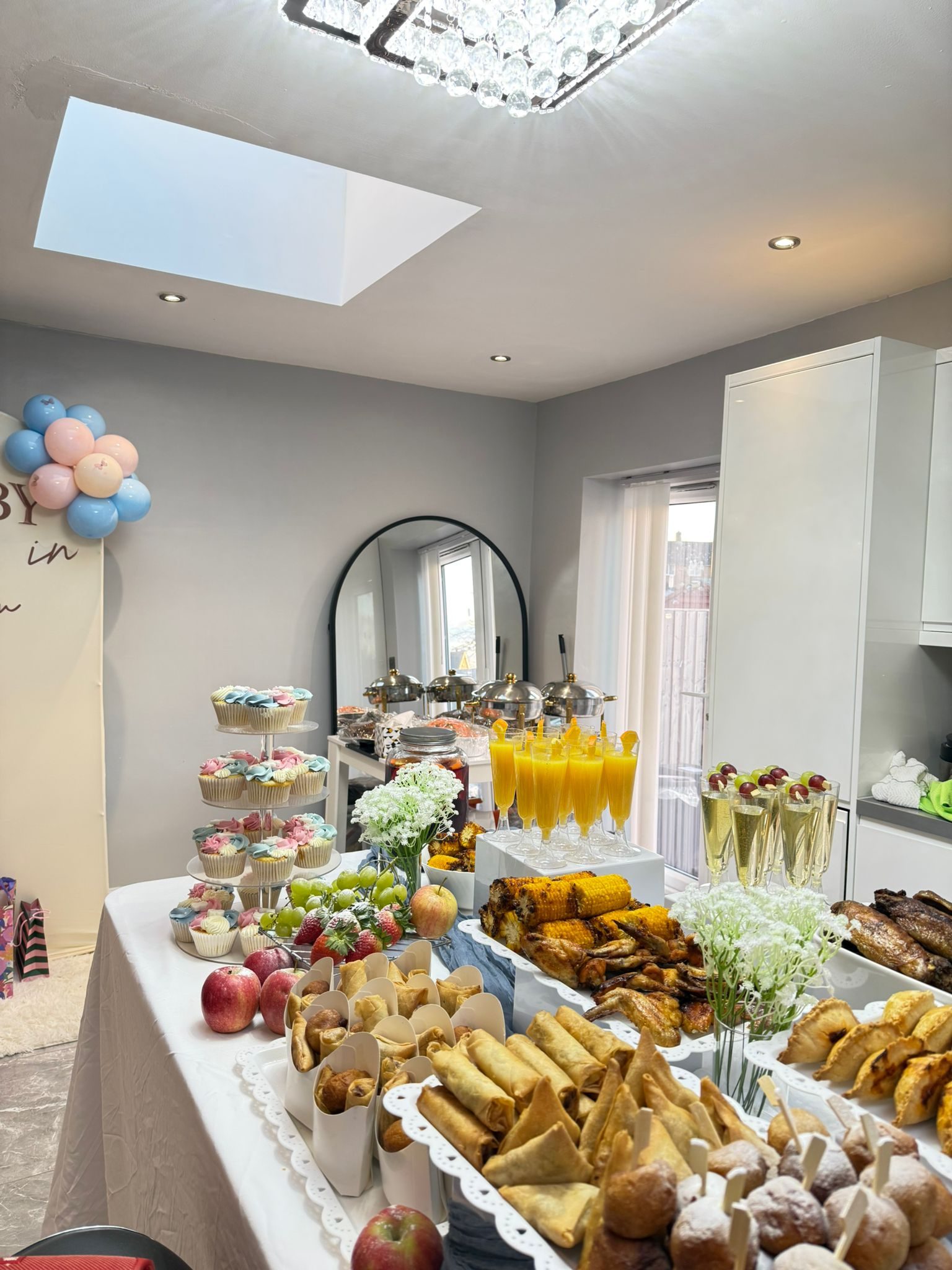 Party buffet spread with cupcakes, spring rolls and drinks